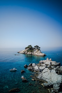 white and blue boat on sea during daytime