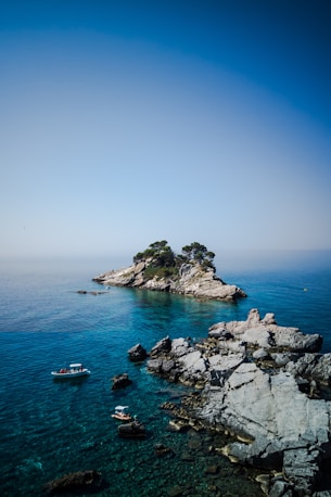 white and blue boat on sea during daytime