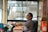 man in brown and white plaid button up shirt sitting on black office rolling chair