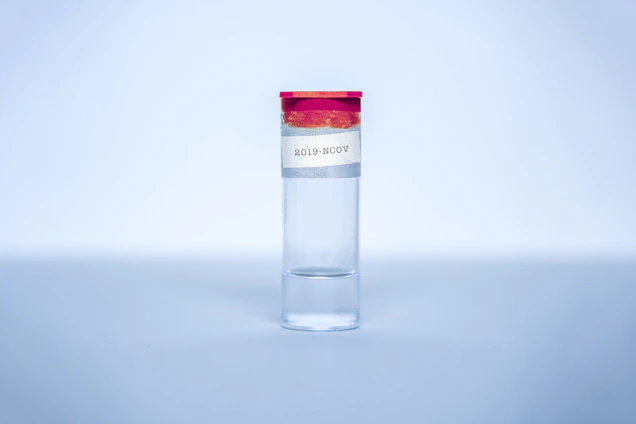 Close-up of a sleek peptide vial with molecular graphics overlay, set against a dark background accented by red, blue, and silver hues inspired by the Puerto Rican flag.