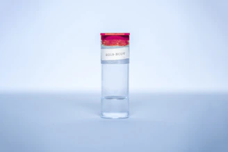 High-resolution image of a certificate of analysis document beside a cobalt blue capped peptide vial.