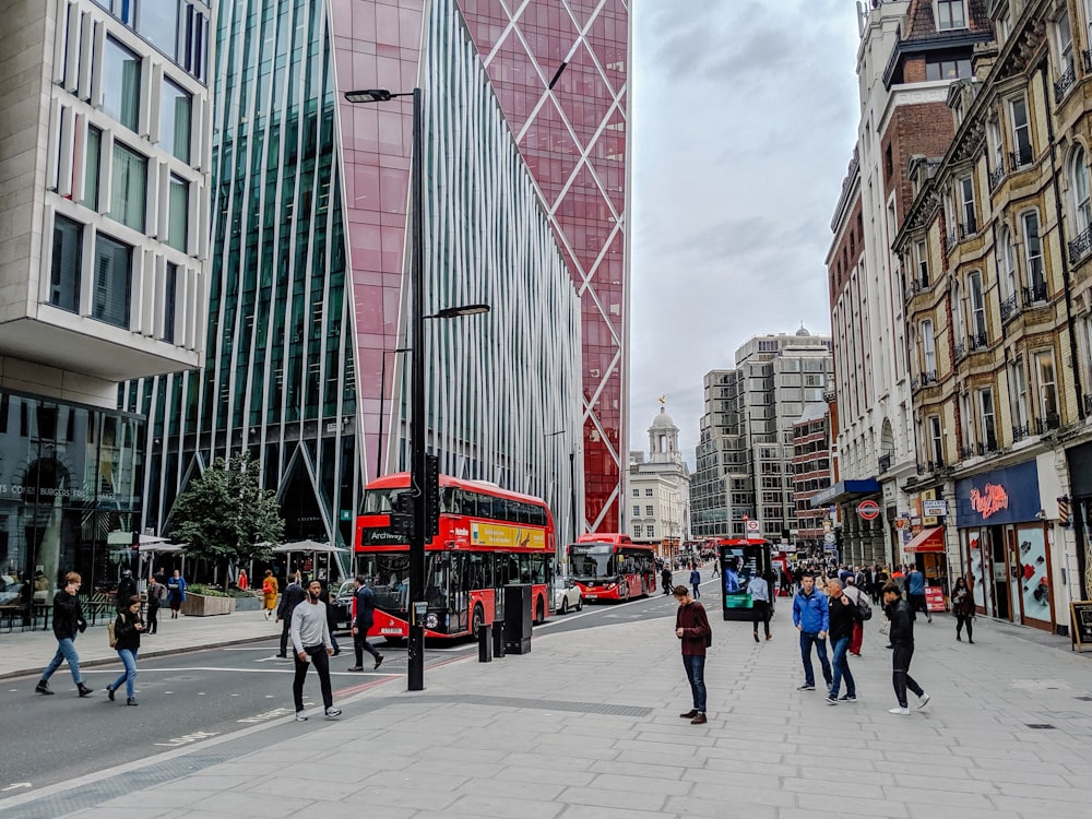 people walking on pedestrian lane near high rise buildings during daytime