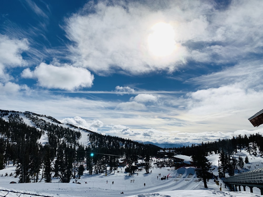 snow covered trees and mountains under blue sky and white clouds during daytime