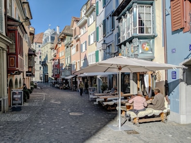 people sitting on chair near brown wooden table and chairs during daytime