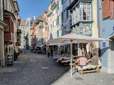 people sitting on chair near brown wooden table and chairs during daytime