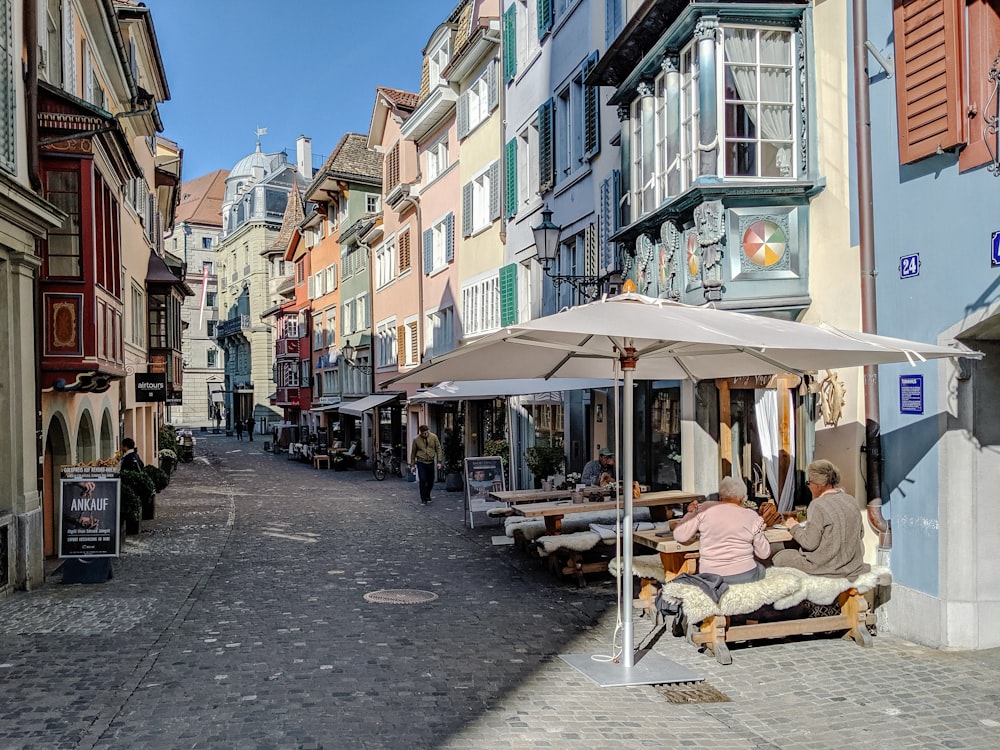 people sitting on chair near brown wooden table and chairs during daytime