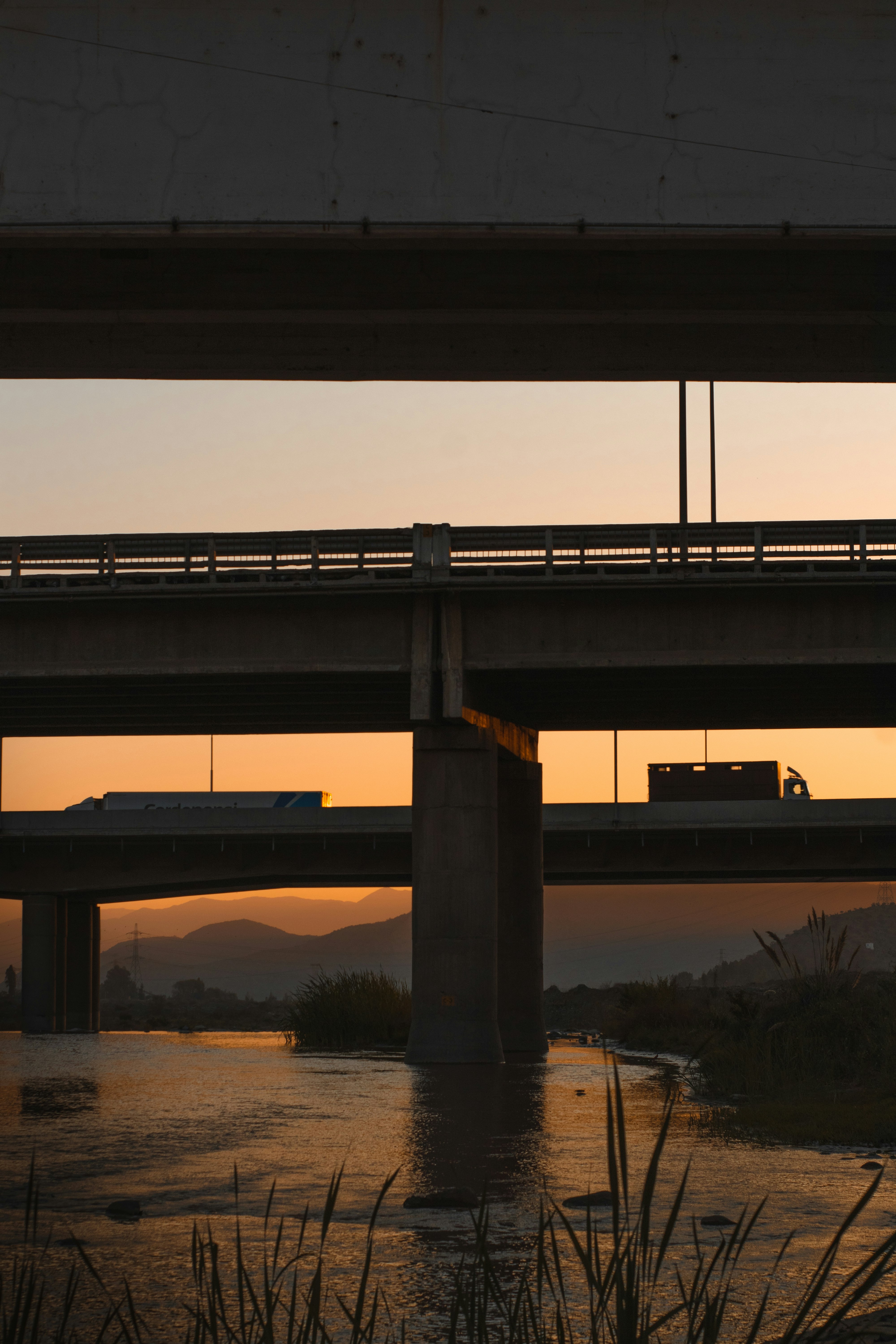 brown concrete bridge over river during daytime