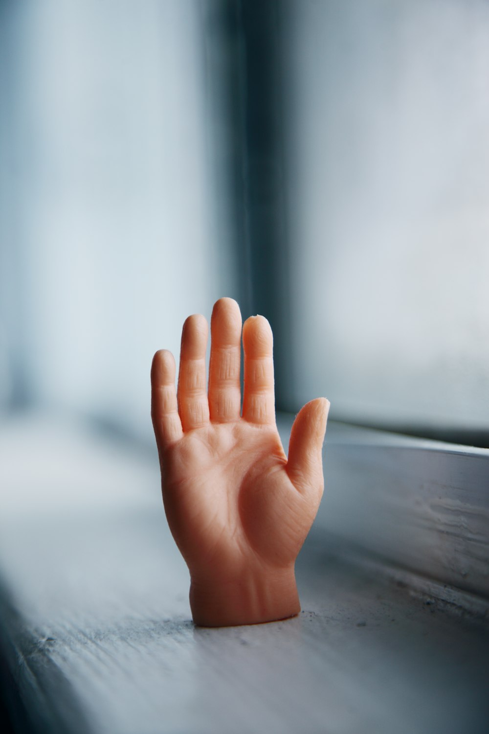 persons left hand on brown wooden table