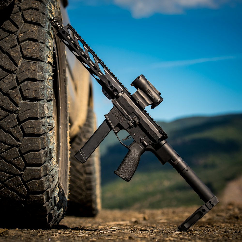 black airsoft rifle on black tire