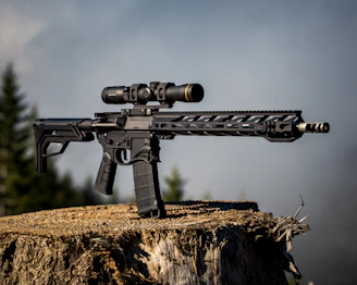 A close-up of a rugged hunting rifle resting against a tree trunk in a forest.