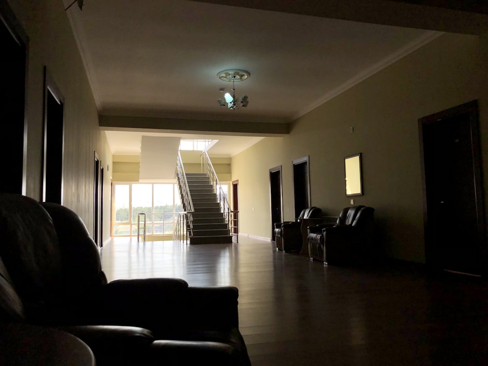 black leather armchair near white window curtain