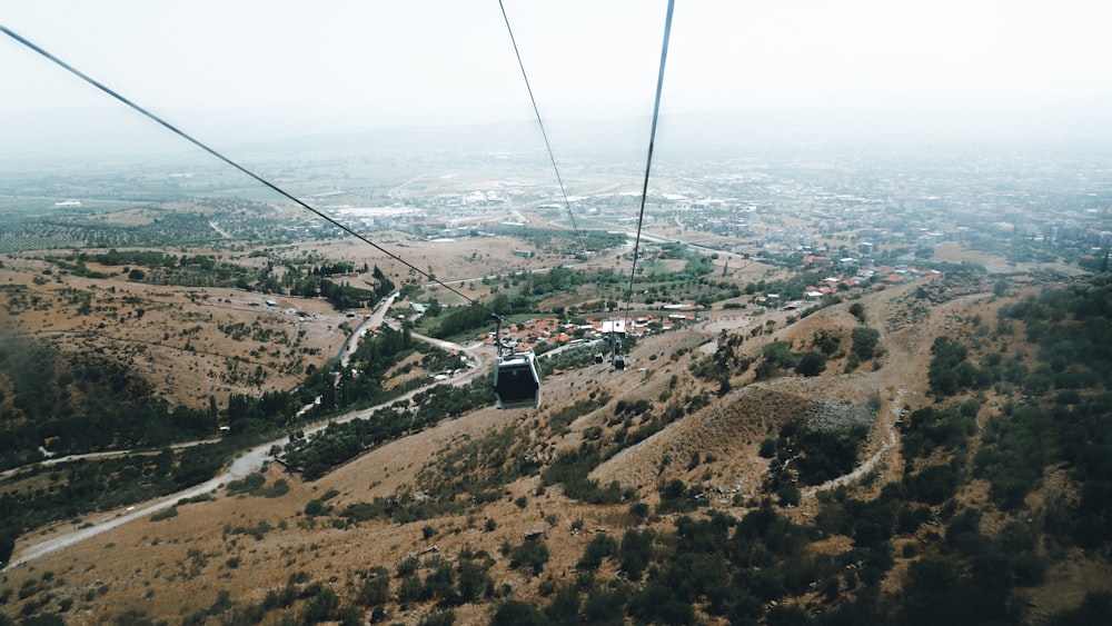 black cable car over the city during daytime