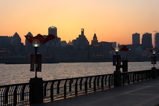 Balcony view overlooking the vibrant Parque das Nações waterfront at sunset.