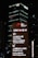A nighttime cityscape features tall buildings, prominently displaying the logos of international banks such as HSBC and Citi, with bright lights and text guiding visitors to various locations including the HSBC Building and the Ritz-Carlton.
