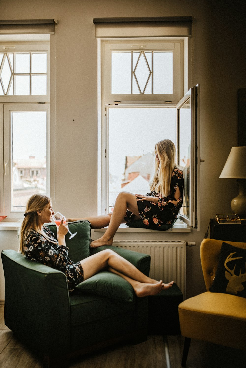 2 women sitting on sofa