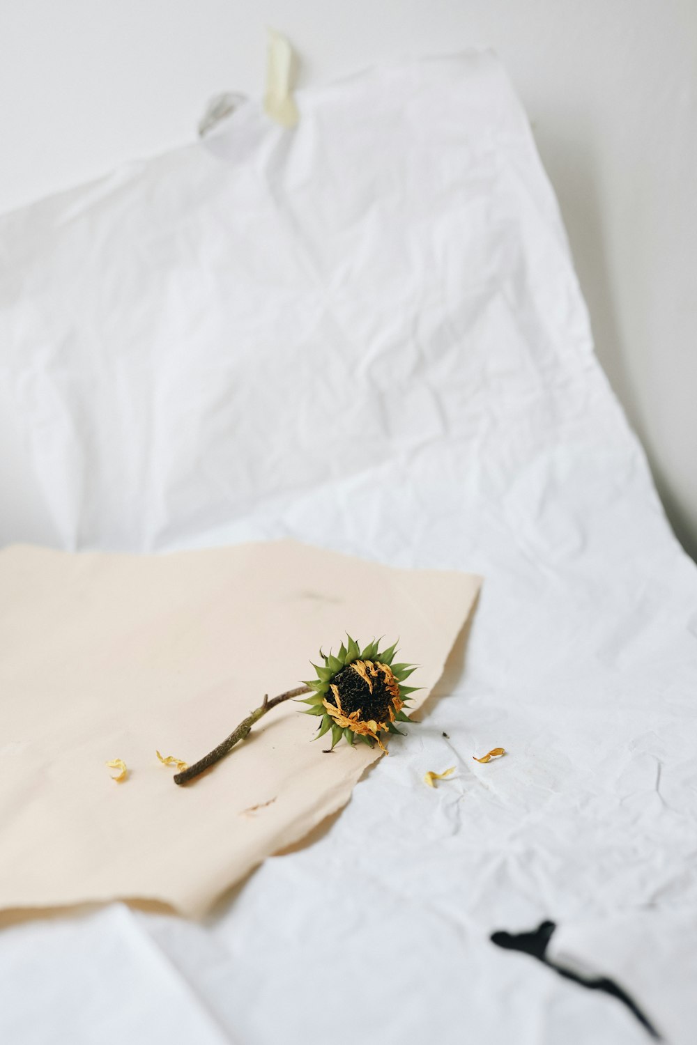 green and yellow flower on white textile