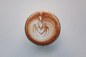 An elegant latte art design in a creamy cappuccino.