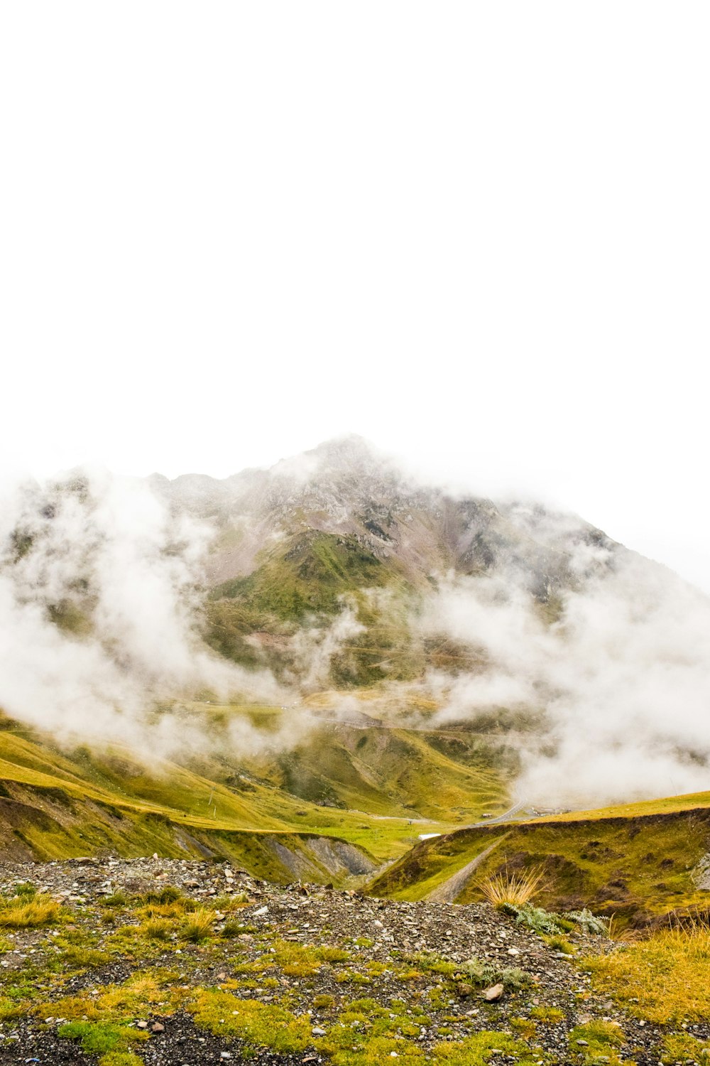 green and yellow mountain under white clouds