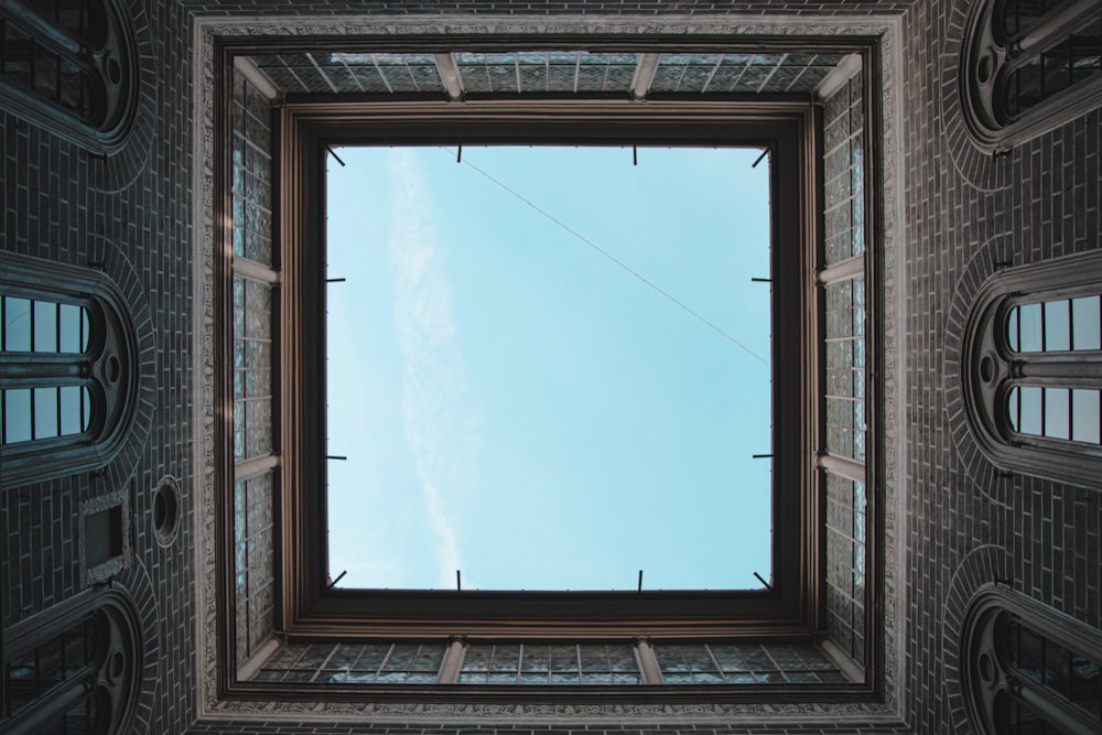 blue sky over brown wooden window