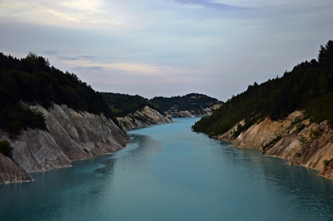 body of water between mountains during daytime