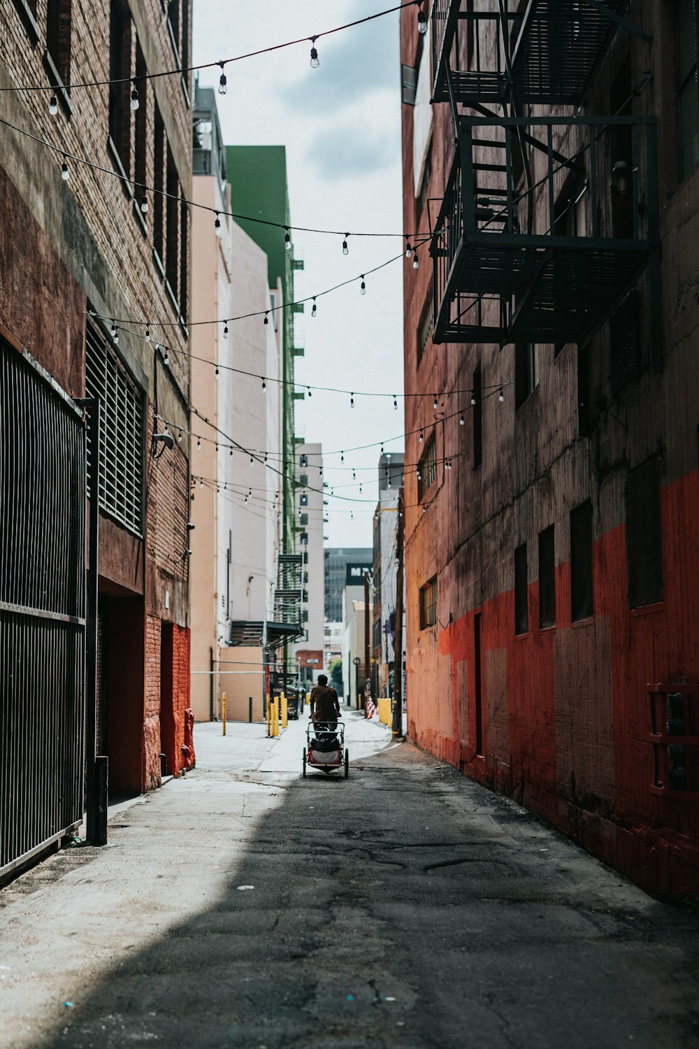 man in black jacket and black pants walking on street during daytime