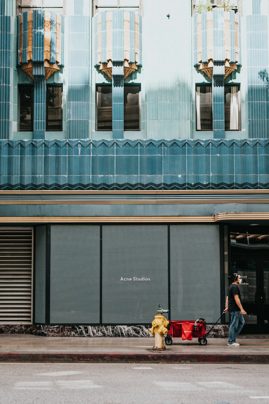 people sitting on bench in front of building during daytime