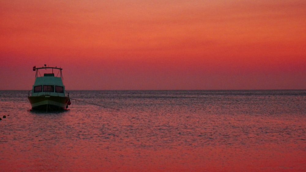 person in black shirt on blue sea during daytime