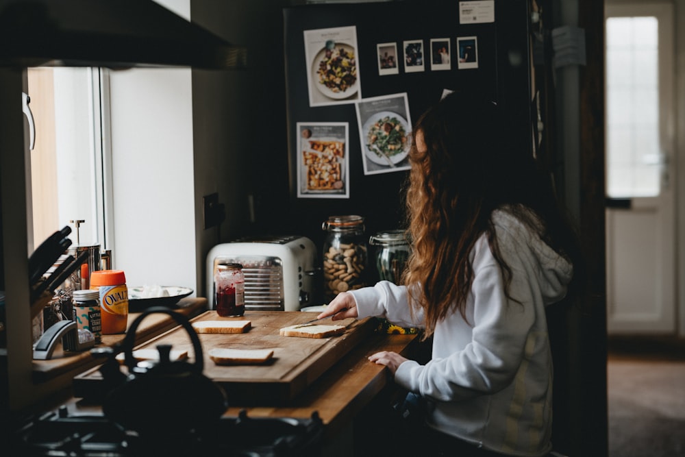 woman in white long sleeve shirt sitting at the table