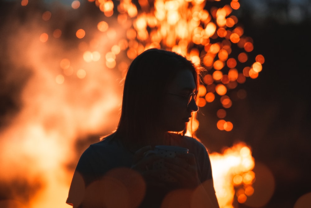 woman in white shirt looking at the sun