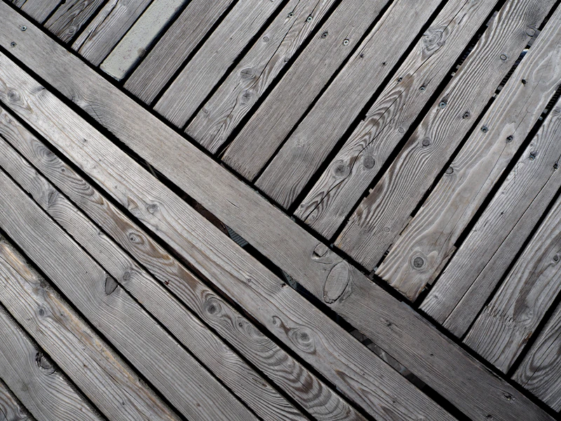 Worn wood deck with peeling sealant