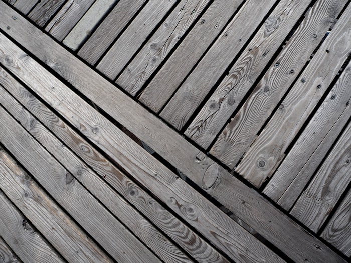 Weathered and peeling deck before staining