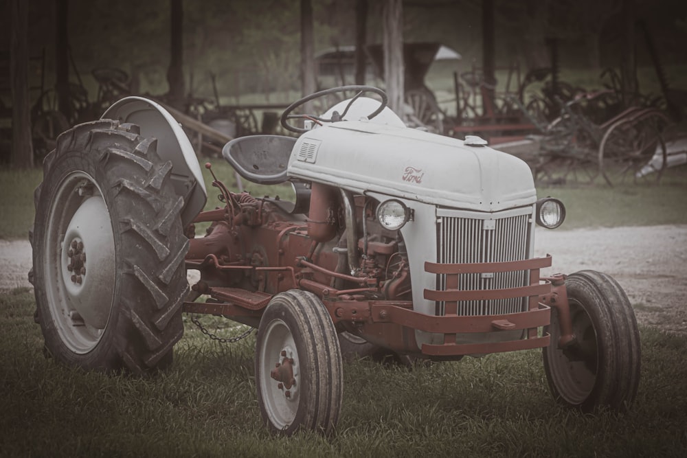 red tractor on green grass field during daytime