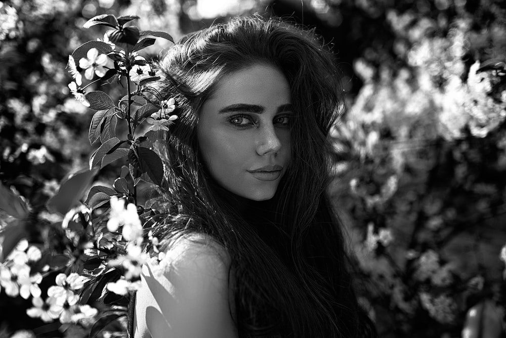 grayscale photo of woman in white tank top