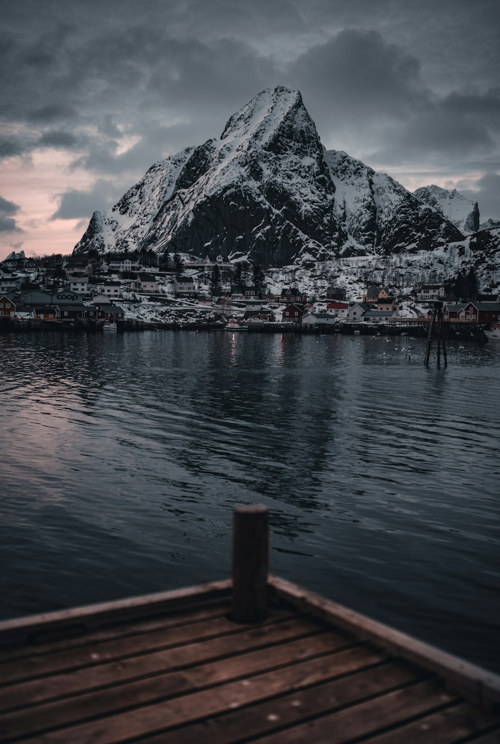 body of water near mountain during daytime