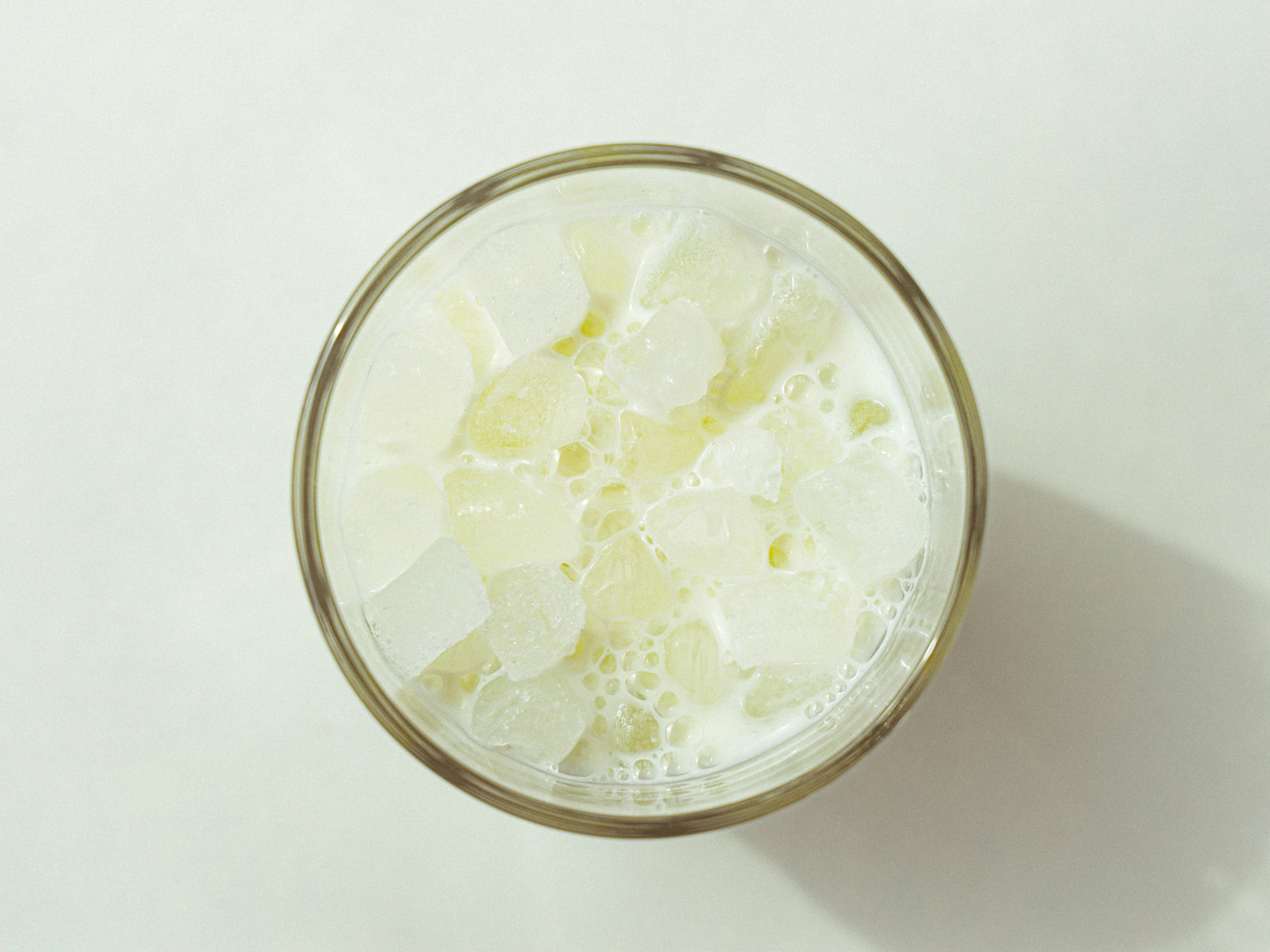 clear drinking glass with white liquid