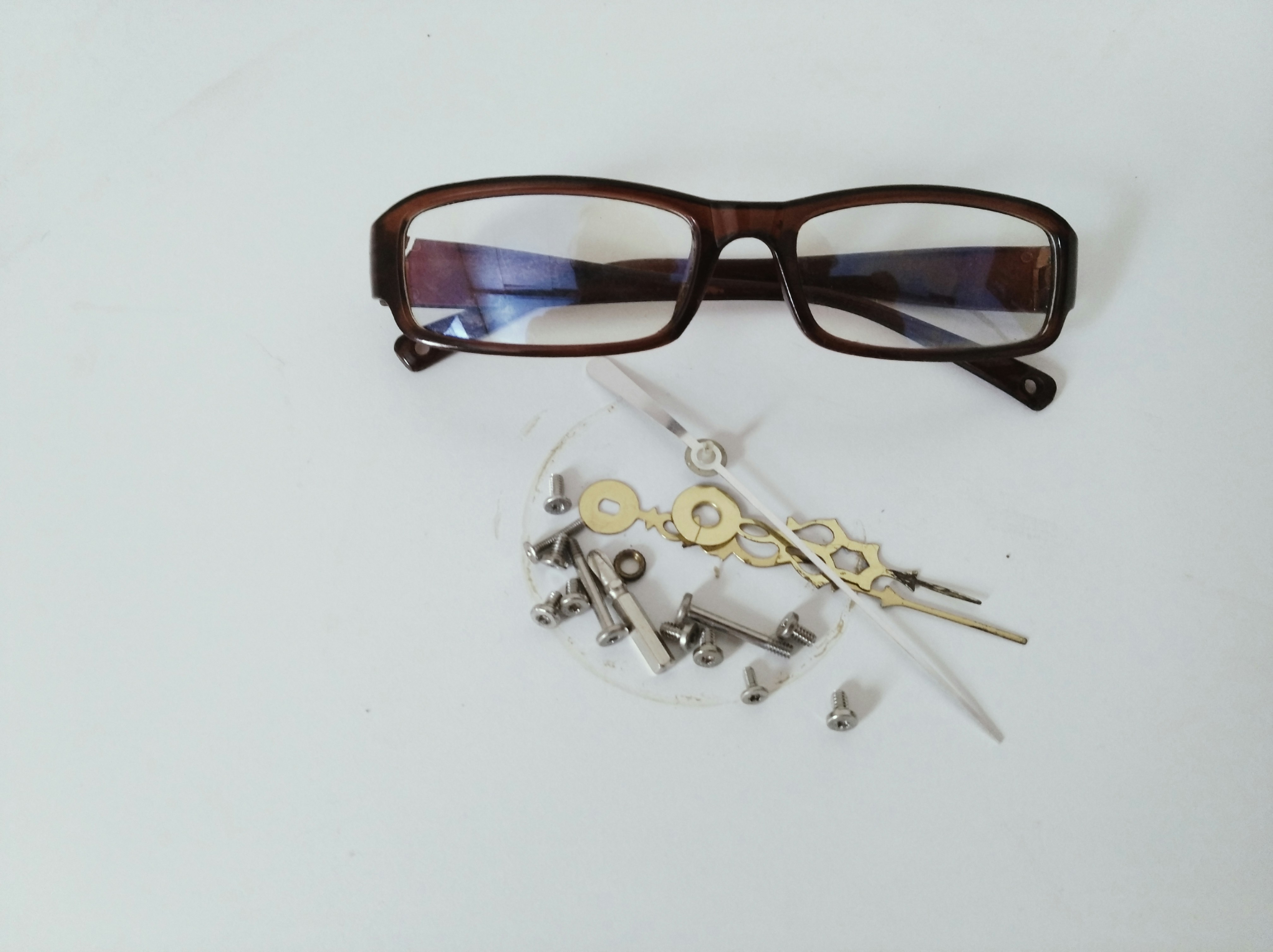 black framed eyeglasses on white table