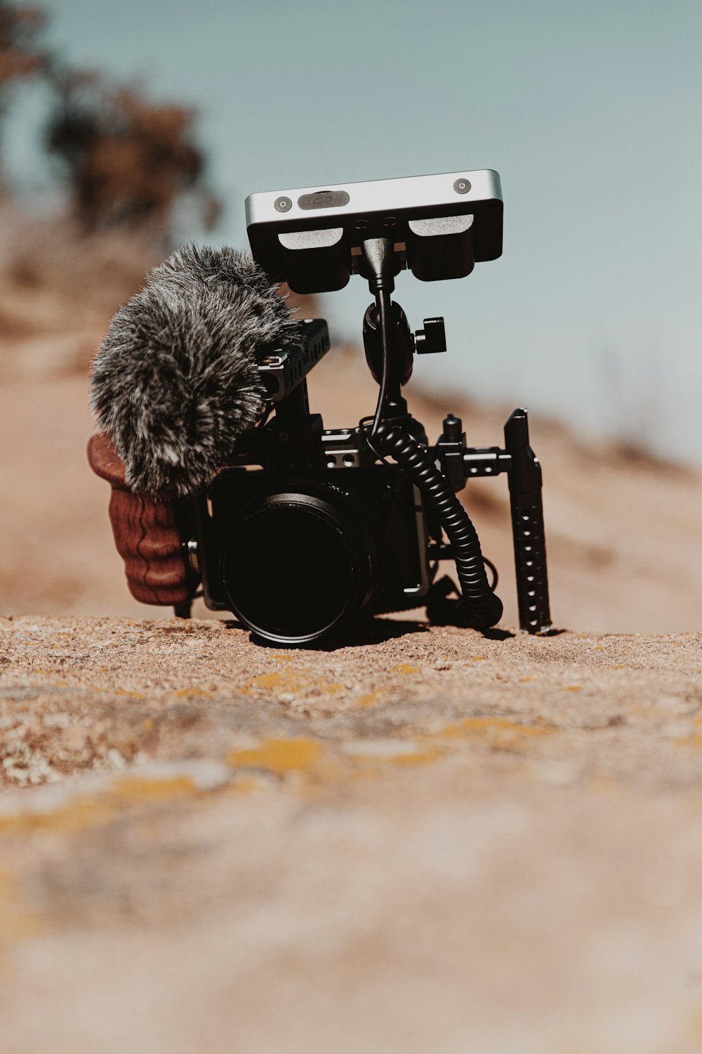 black and gray dslr camera on brown soil