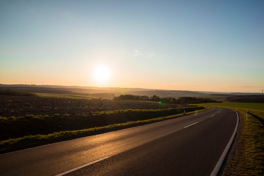 gray asphalt road during sunset