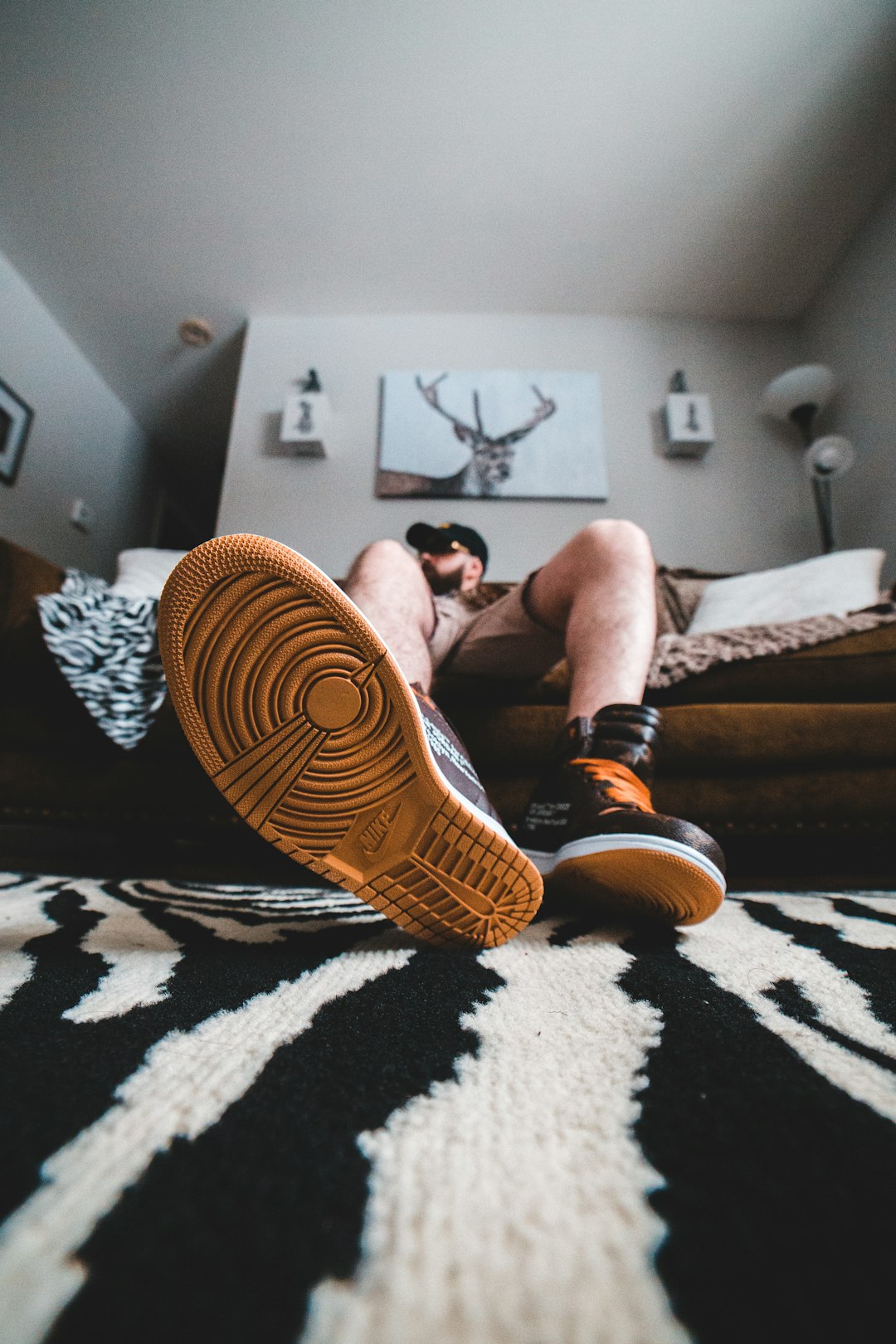 man in black shorts lying on bed