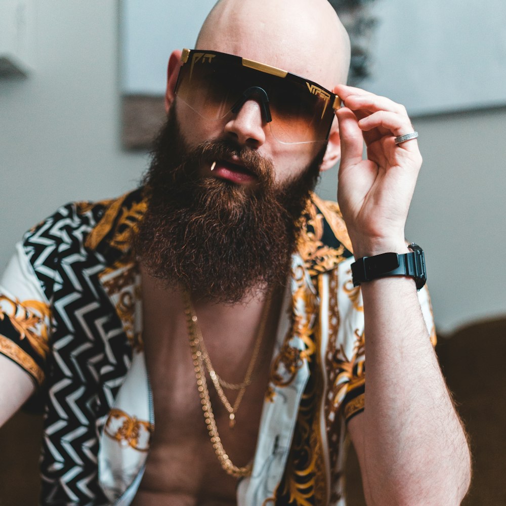 man in black and brown floral shirt wearing black sunglasses