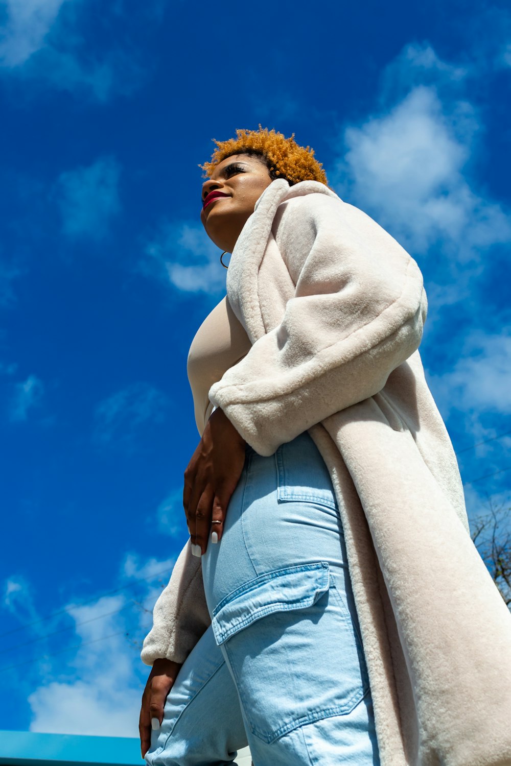 woman in white scarf and blue denim shorts