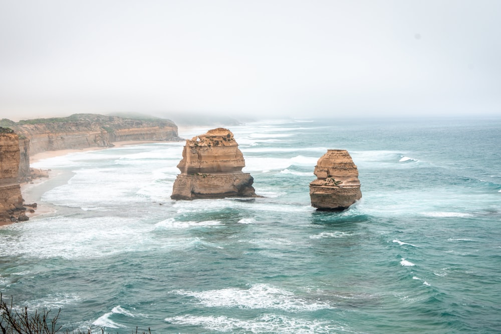 brown rock formation on sea during daytime