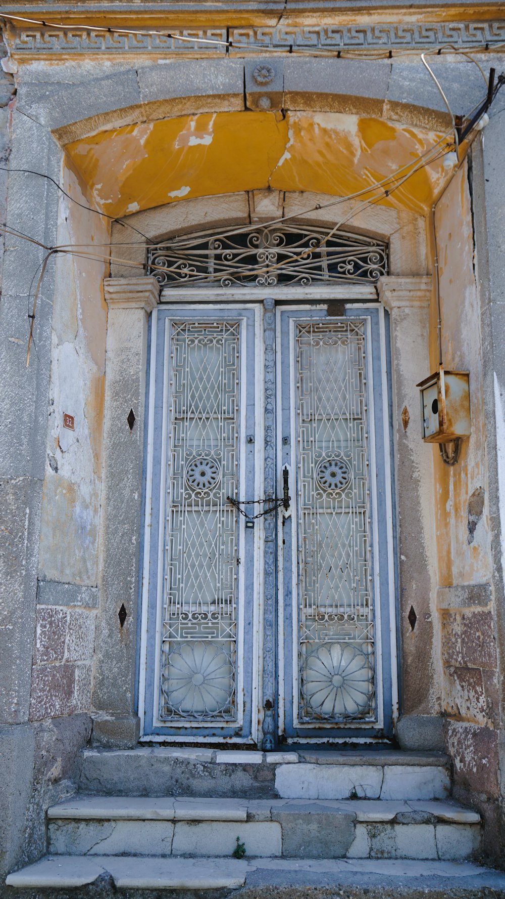 puerta de madera azul sobre pared de hormigón marrón