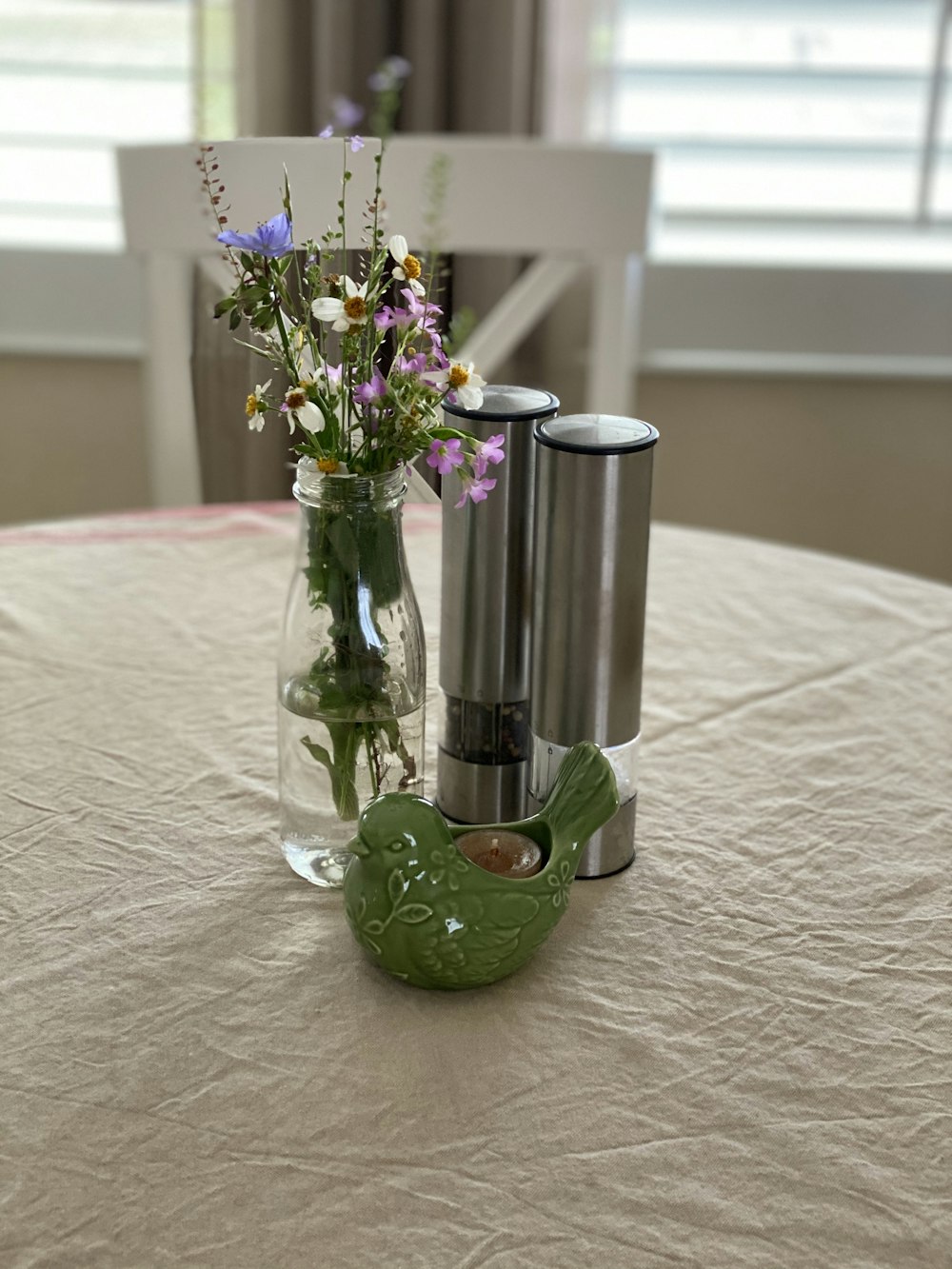 purple flowers in green glass vase