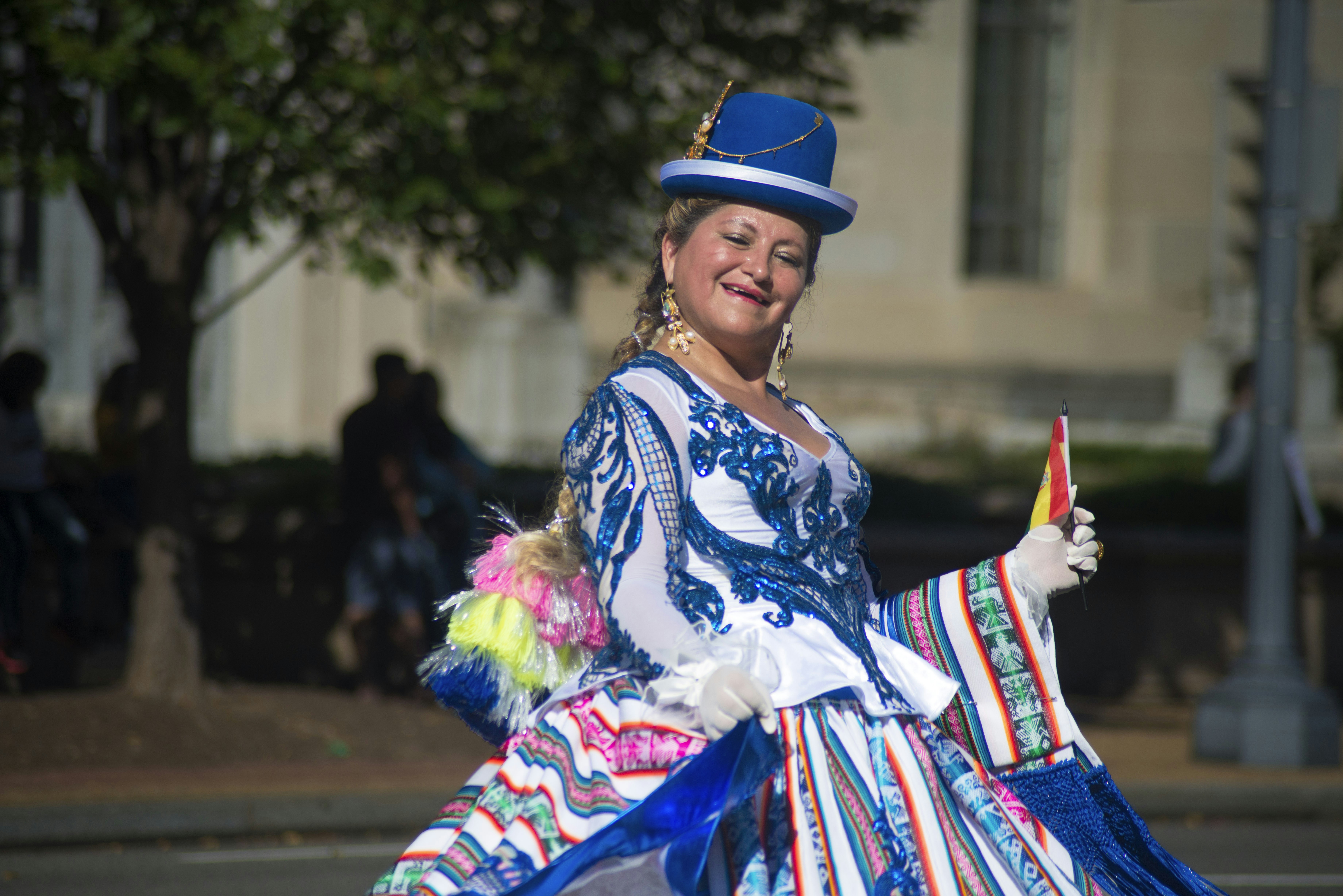 woman in white blue and red dress holding purple stick