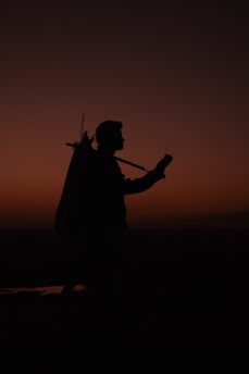 Faceless silhouette of a person walking confidently at dawn, symbolizing new beginnings and discipline.