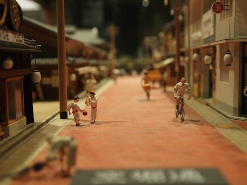 A miniature street scene from Bengaluru with tiny hand-painted figures and vibrant storefronts.