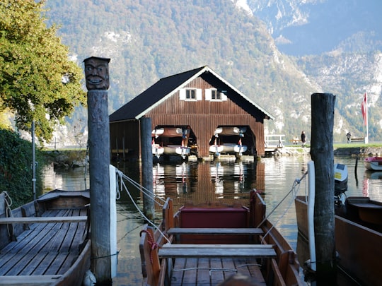 brown wooden house near lake during daytime in Mondsee Austria