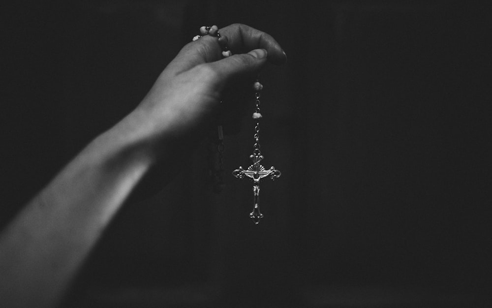 grayscale photo of person holding water