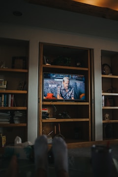 A handyman installing shelves inside a cozy living room.